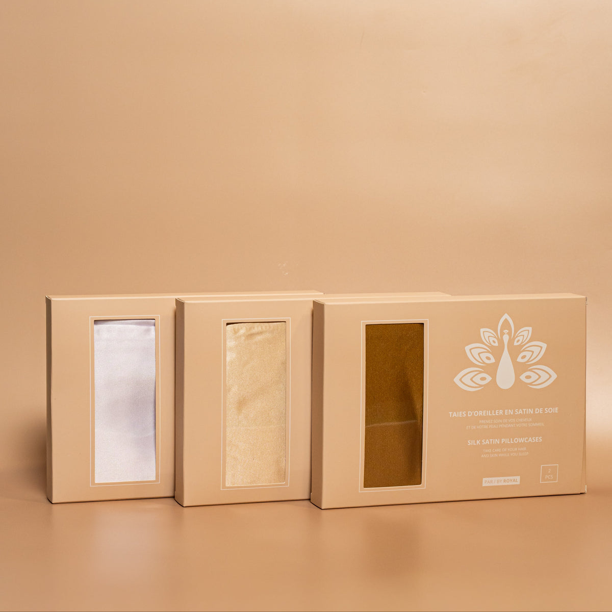 ROYAL Silk Satin Pillowcases in three colors, designed to help protect hair and skin while sleeping.