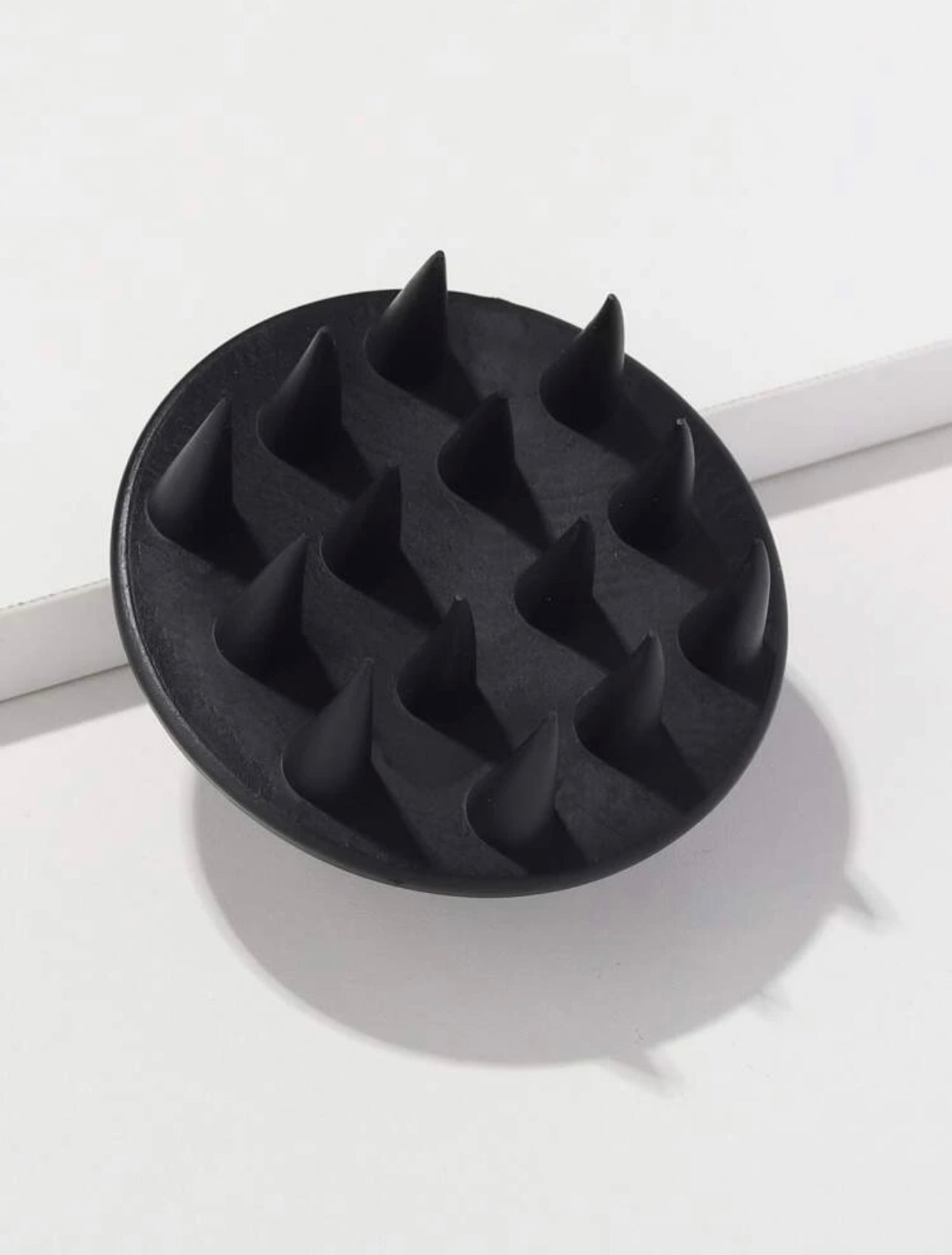 oyal black scalp massage brush, designed to gently stimulate the scalp, improve blood circulation, and promote healthy hair growth.