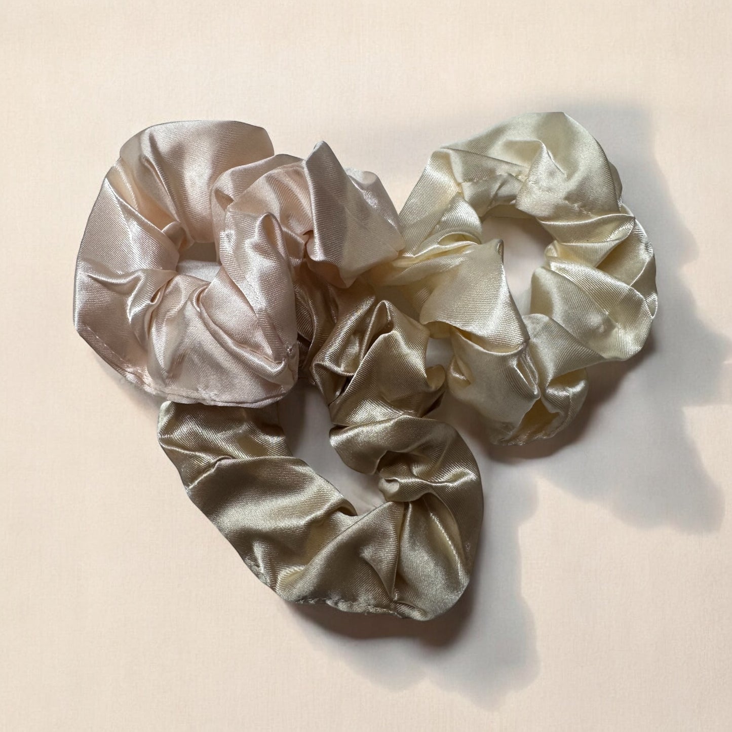 Set of 3 Royal satin hair scrunchies in beige, designed to gently hold hair without causing breakage or creases, while adding a stylish touch.