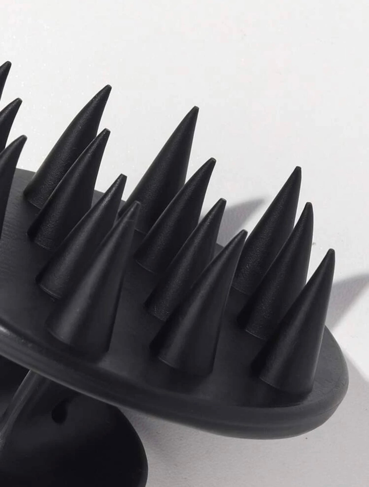 Close-up of the bristles of the Royal black scalp massage brush, highlighting their flexible tips designed to gently massage the scalp and promote healthy hair.