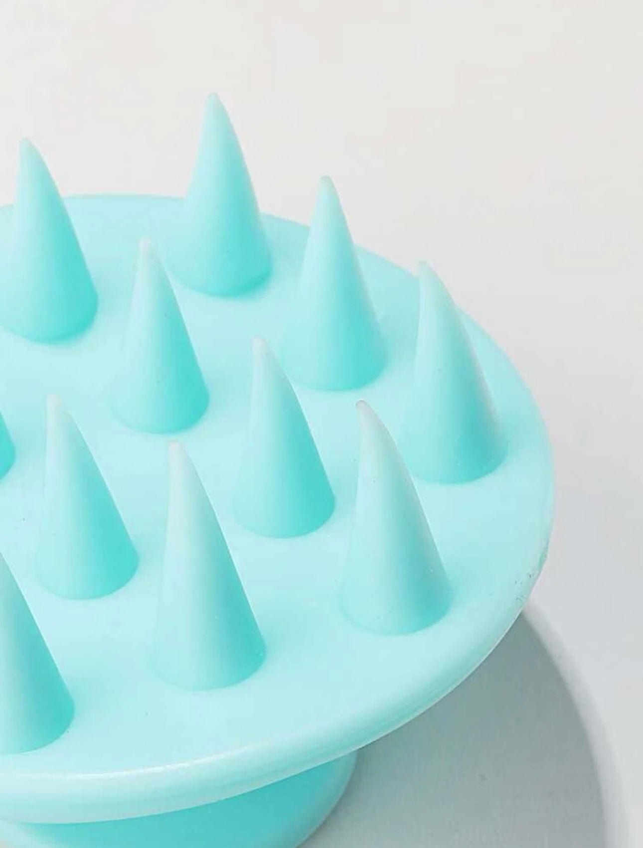 Close-up of the bristles of the Royal blue scalp massage brush, highlighting their flexible tips designed to gently massage the scalp and promote healthy hair.