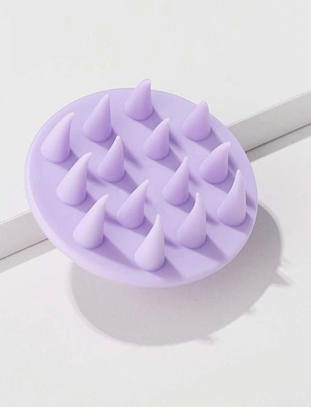 Royal purple scalp massage brush, designed to gently stimulate the scalp, improve blood circulation, and promote healthy hair growth.